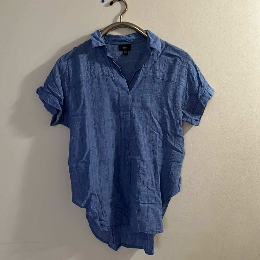 Loose fitting blue blouse.
